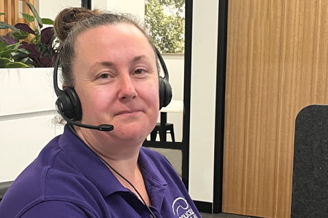 Client Services Officer wearing headphones