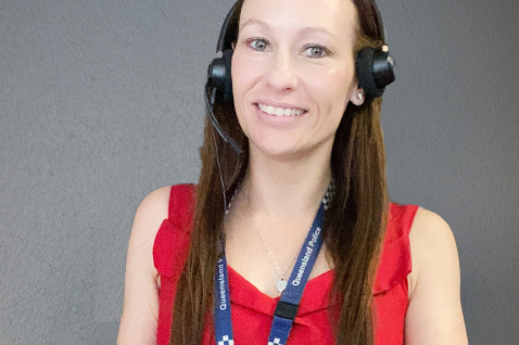 A photo of a QPS Communication operator wearing headphones