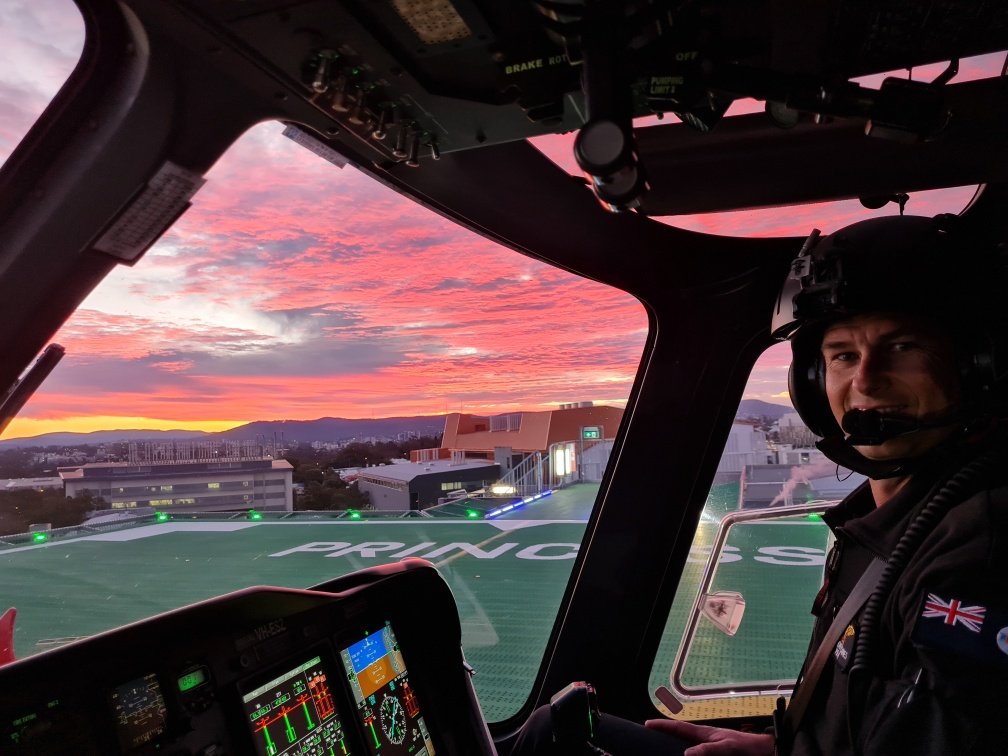 Photo of pilot from inside the cockpit of an aircraft.