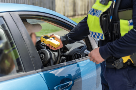police officer performing roadside breath test