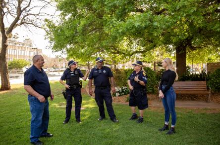 police officers talk with community in a park