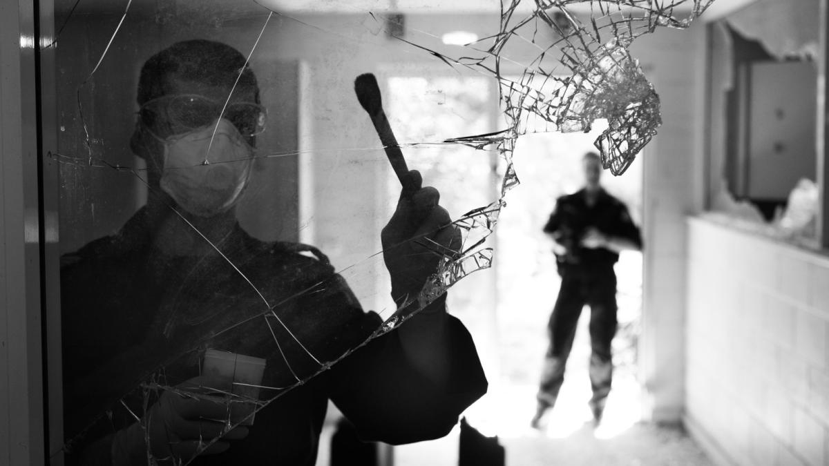 Forensic officer dusting for fingerprints