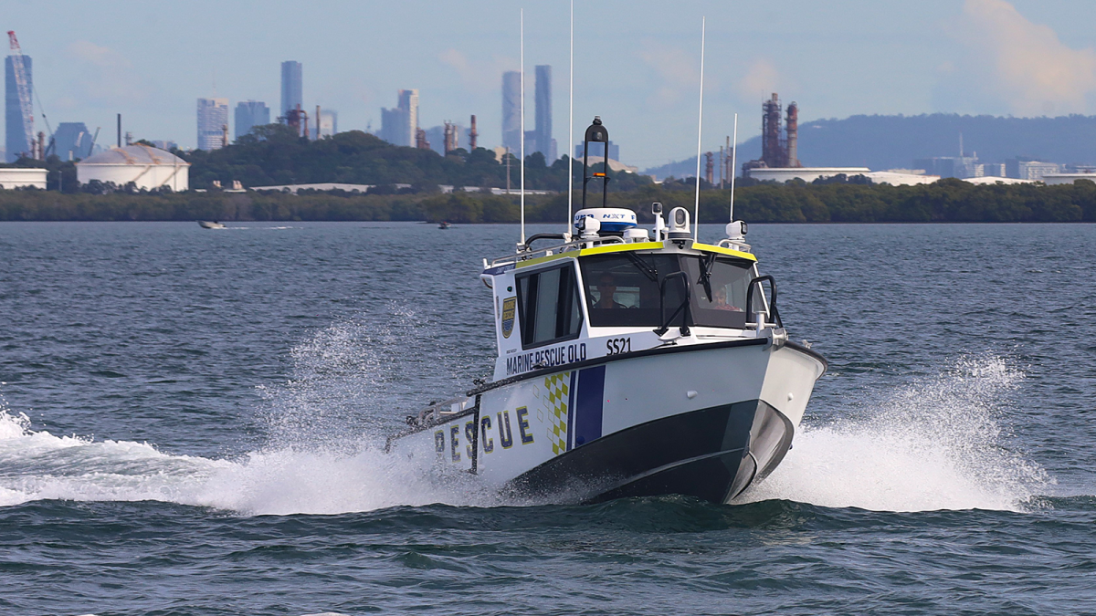 Marine Rescue Queensland boat at sea with city skyline in the background