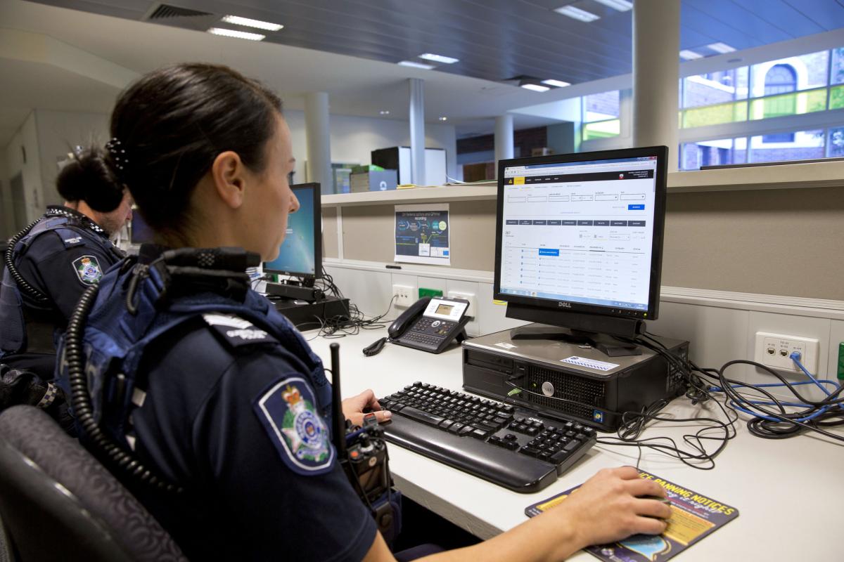 Police officer sitting at a computer