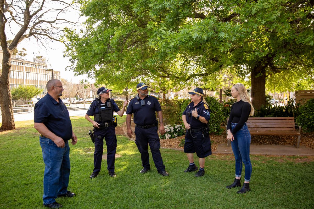 police officers talk with community in a park