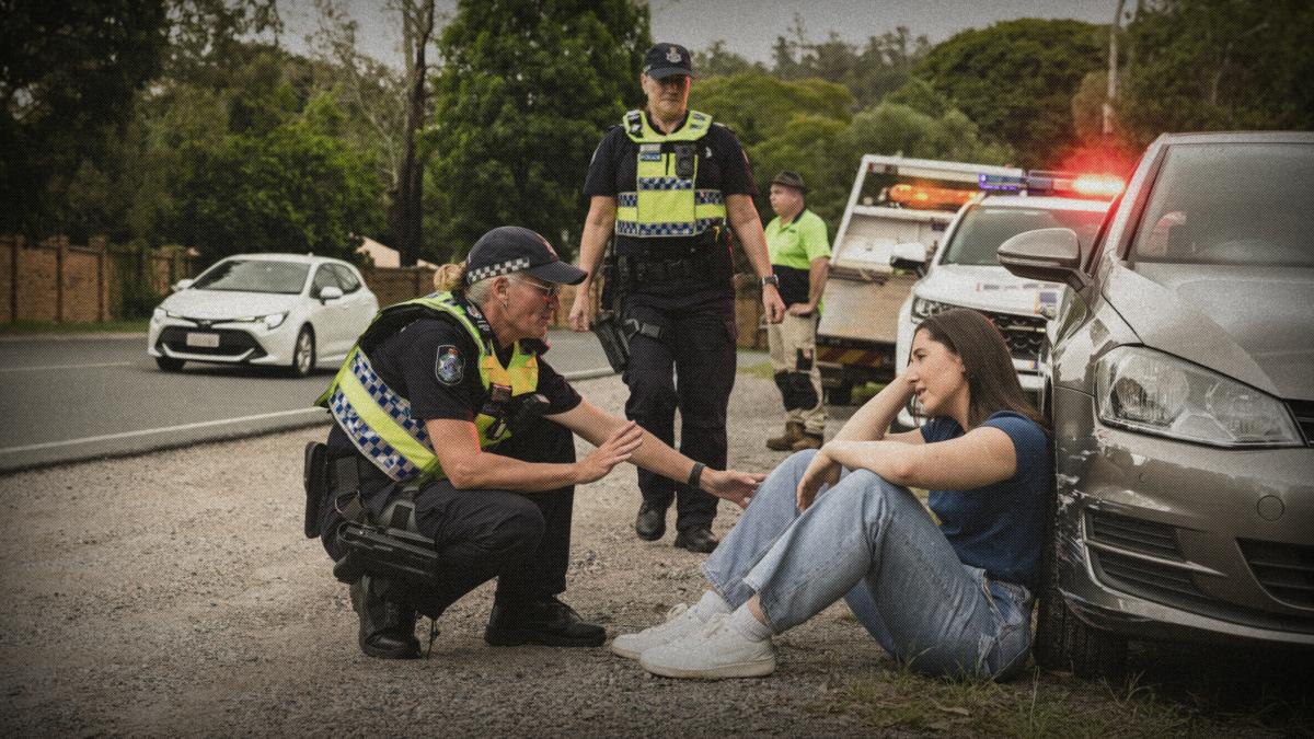police officers talk to young woman after car crash