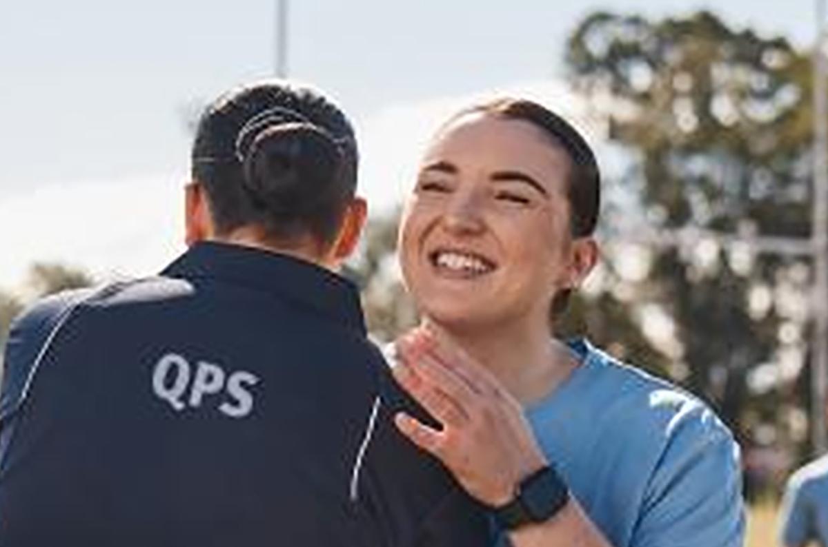 Happy woman hugging QPS person
